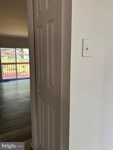 a kitchen with stainless steel appliances a refrigerator and wooden floor