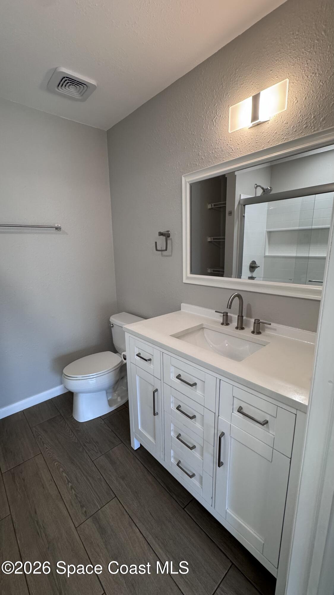 2137 Laden Road Melbourne, FL 32935 - Photo 11 of 23 a bathroom with a double vanity sink and a toilet