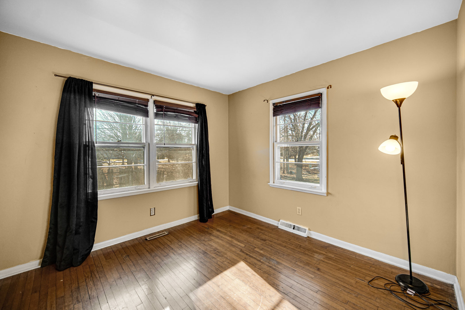 2564 Plainfield Road Joliet, IL 60435 - Photo 11 of 20 a view of an empty room with a window and wooden floor