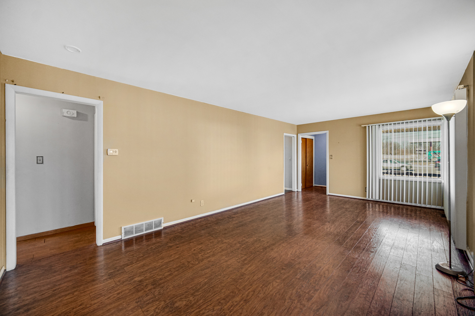 2564 Plainfield Road Joliet, IL 60435 - Photo 3 of 20 an empty room with wooden floor and windows