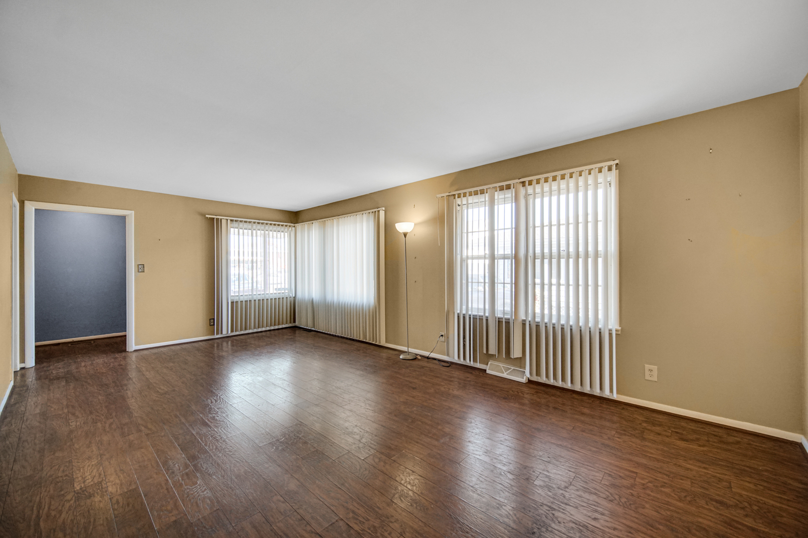 2564 Plainfield Road Joliet, IL 60435 - Photo 4 of 20 an empty room with wooden floor and windows
