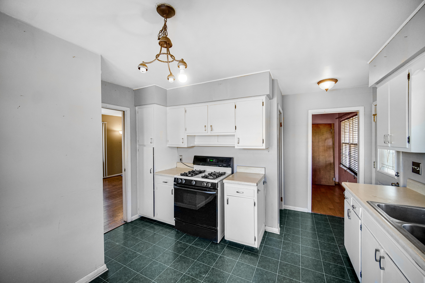 2564 Plainfield Road Joliet, IL 60435 - Photo 7 of 20 a kitchen with a stove sink and refrigerator