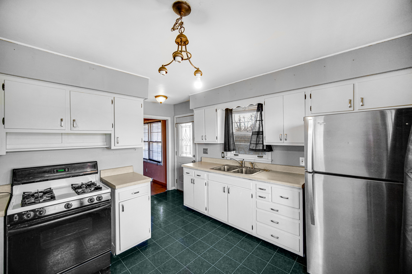 2564 Plainfield Road Joliet, IL 60435 - Photo 8 of 20 a kitchen with stainless steel appliances granite countertop a sink stove and refrigerator