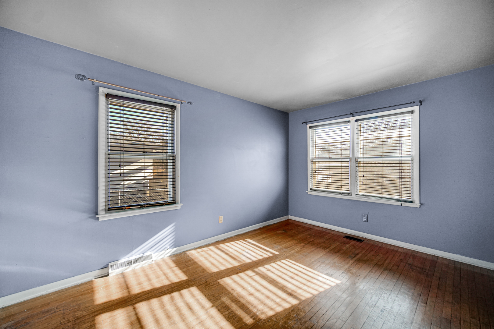 2564 Plainfield Road Joliet, IL 60435 - Photo 10 of 20 a view of an empty room with wooden floor and a window
