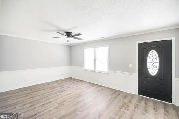 wooden floor in an empty room with a window