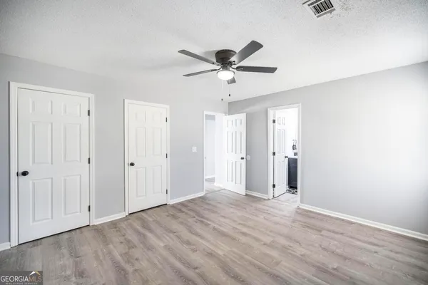 a view of an empty room and wooden floor
