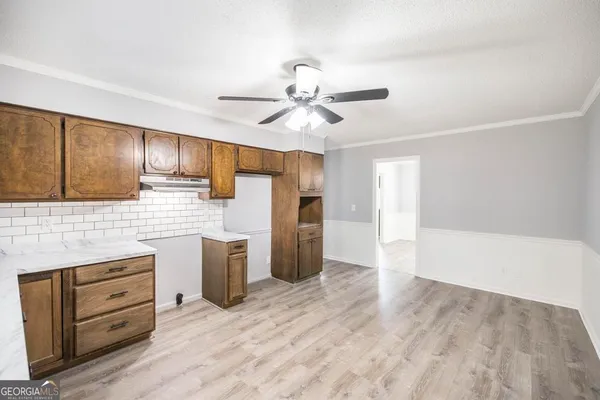 a kitchen with a refrigerator and cabinets