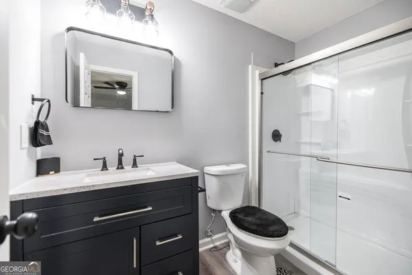a bathroom with a toilet a sink and mirror