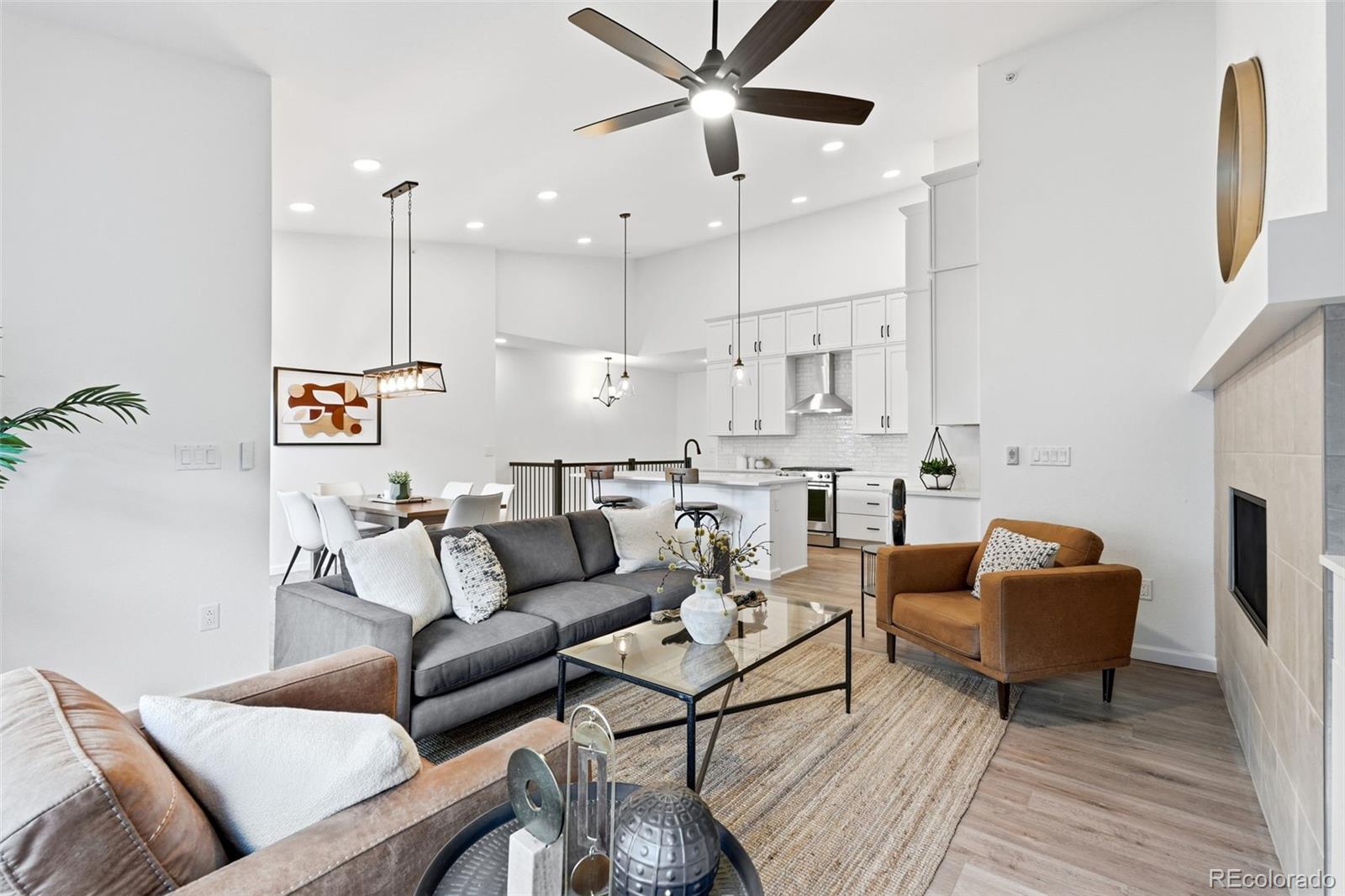 8283 South Queen Street Littleton, CO 80127 - Photo 11 of 46 a living room with furniture kitchen view and a chandelier