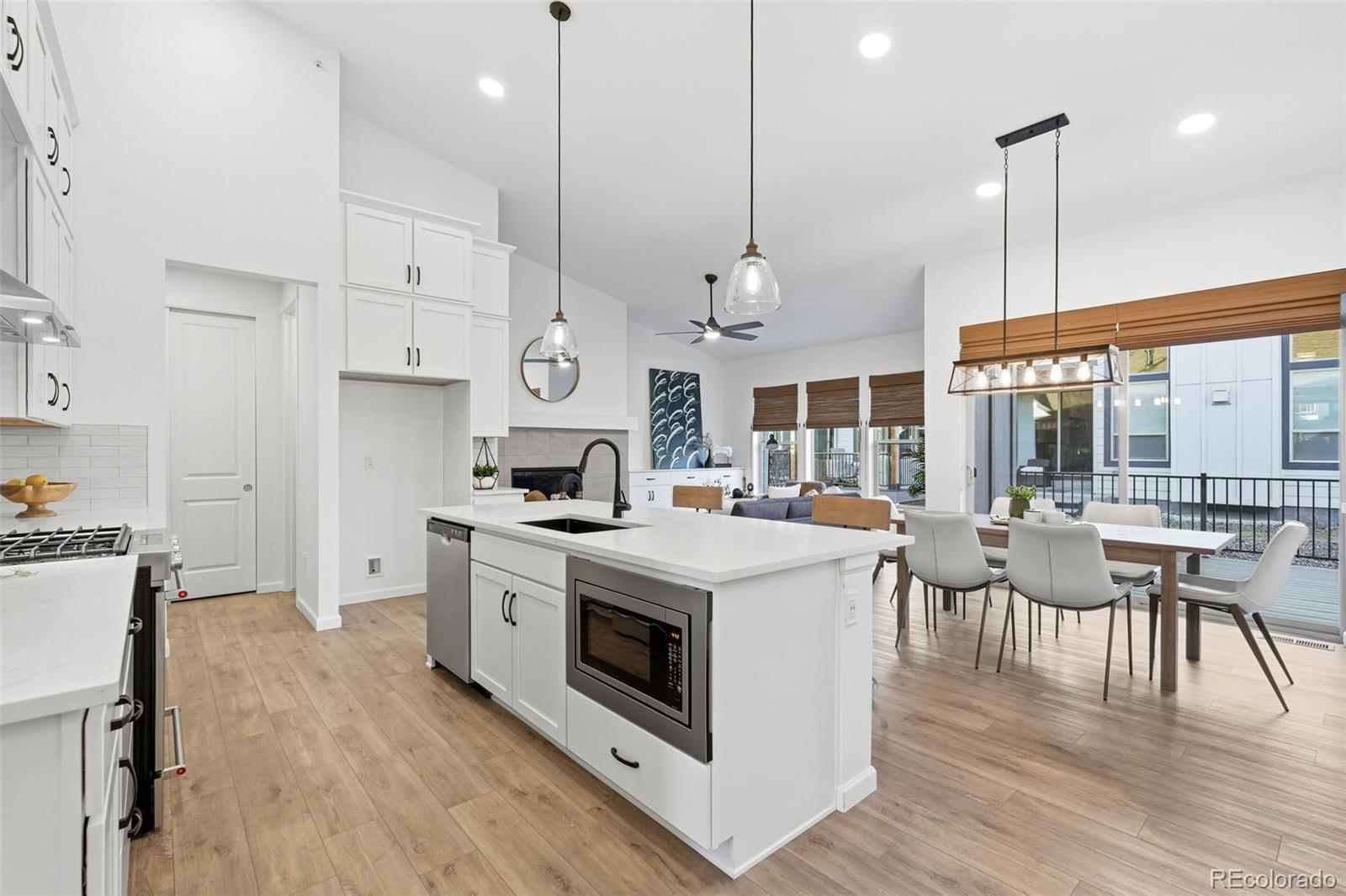 8283 South Queen Street Littleton, CO 80127 - Photo 18 of 46 a kitchen with stove and wooden floor