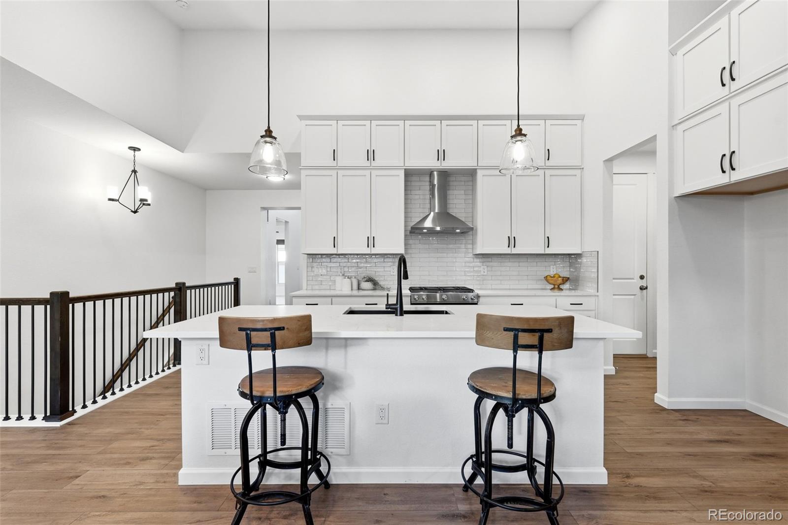 8283 South Queen Street Littleton, CO 80127 - Photo 19 of 46 a kitchen with stainless steel appliances a stove a table and chairs in it