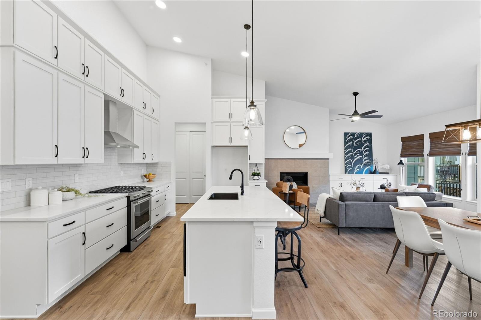 8283 South Queen Street Littleton, CO 80127 - Photo 20 of 46 a kitchen with furniture a refrigerator and a fireplace