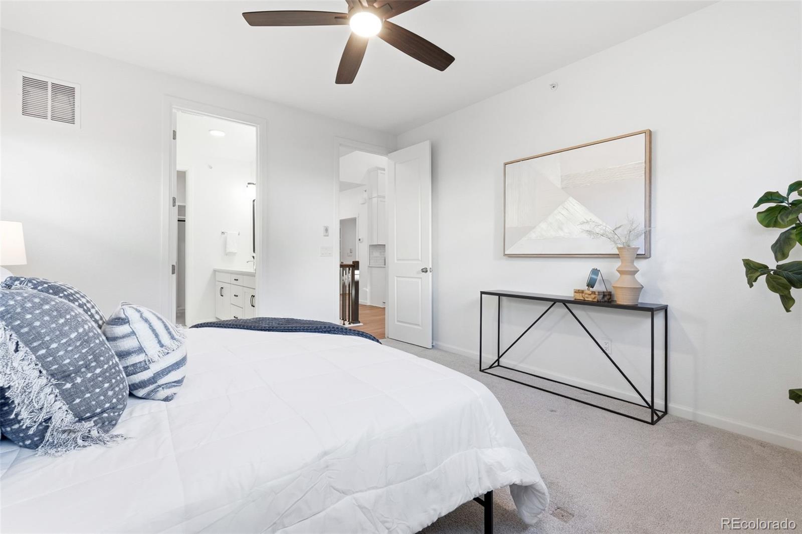 8283 South Queen Street Littleton, CO 80127 - Photo 23 of 46 a bedroom with a bed and a painting on the wall