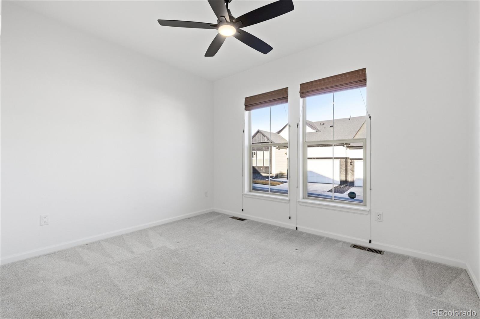 8283 South Queen Street Littleton, CO 80127 - Photo 27 of 46 an empty room with a empty space and windows