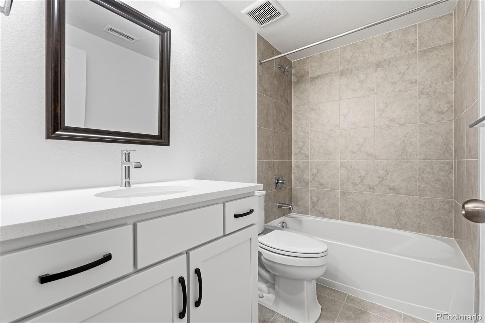 8283 South Queen Street Littleton, CO 80127 - Photo 29 of 46 a bathroom with a sink a toilet and a bathtub