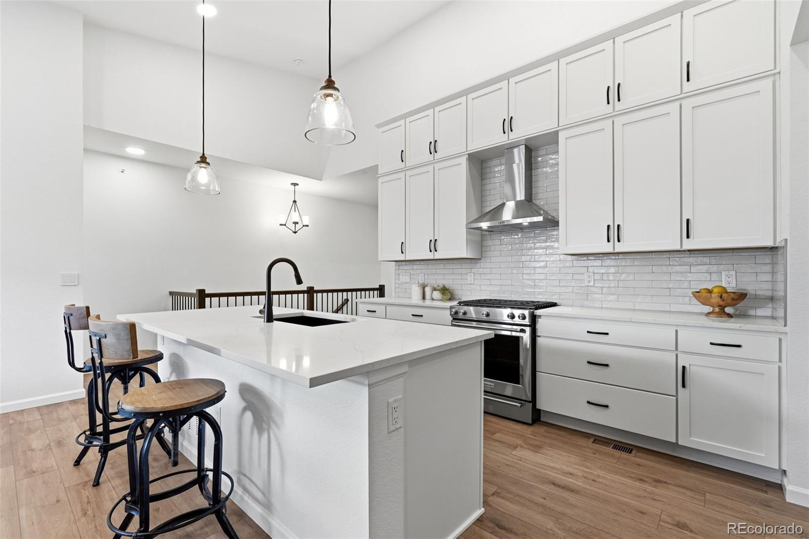 8283 South Queen Street Littleton, CO 80127 - Photo 3 of 46 a kitchen with stainless steel appliances granite countertop a sink a stove and a refrigerator