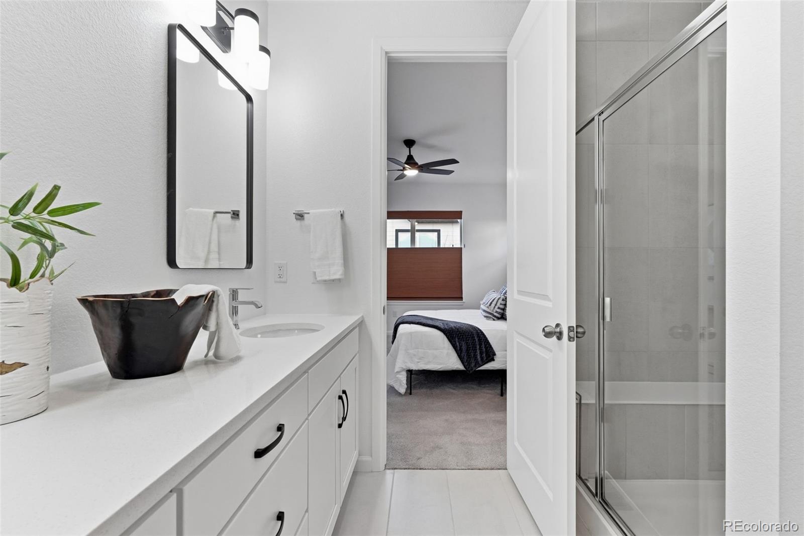 8283 South Queen Street Littleton, CO 80127 - Photo 5 of 46 a bathroom with a sink and a mirror