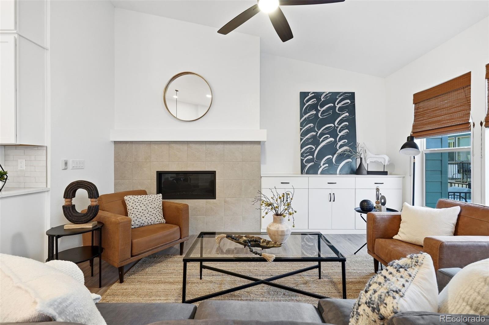 8283 South Queen Street Littleton, CO 80127 - Photo 10 of 46 a living room with furniture a rug and a fireplace