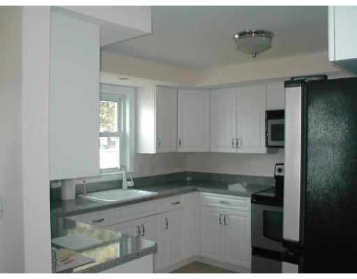48 Miriam Road Waltham, MA 02451 - Photo 7 of 10 a kitchen with granite countertop white cabinets and a sink