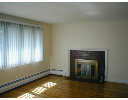 48 Miriam Road Waltham, MA 02451 - Photo 9 of 10 a view of a livingroom with a fireplace and window