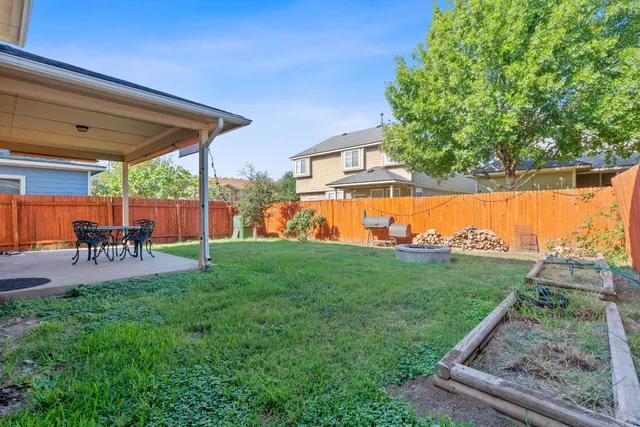 a view of a backyard with sitting area