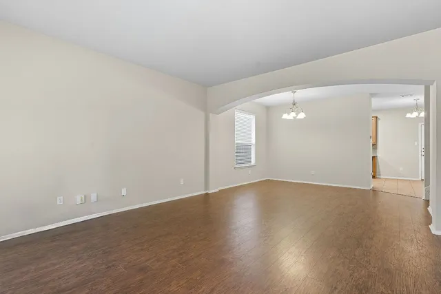 a view of an empty room and wooden floor