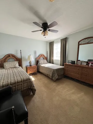 a living room with stainless steel appliances kitchen island granite countertop a refrigerator and a sink