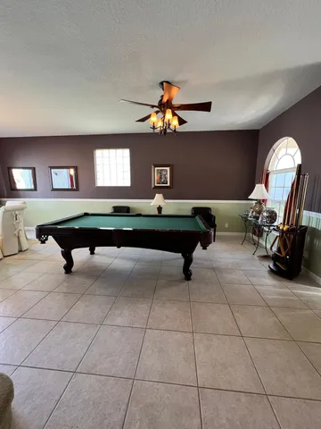 a large kitchen with stainless steel appliances granite countertop a refrigerator and a stove