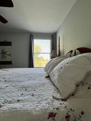 a living room with furniture a window and a flat screen tv