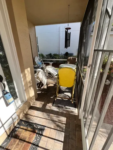 a view of a house with a big yard and flower plants