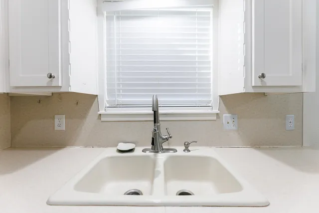 a bathroom with a sink and a window