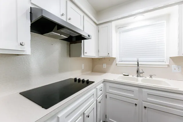 a kitchen with a sink and cabinets