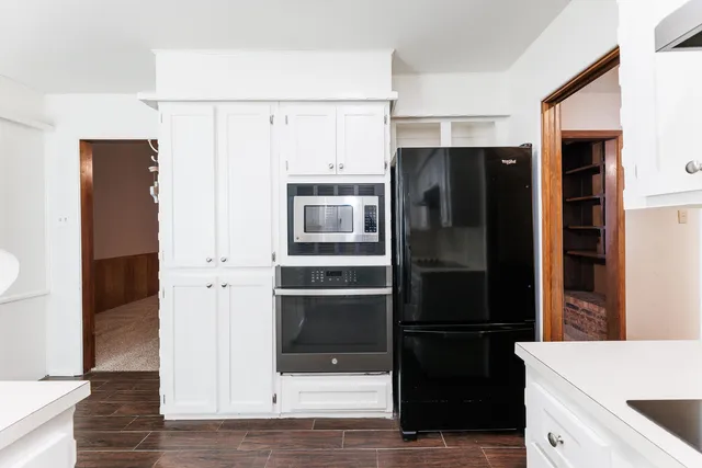 a kitchen with stainless steel appliances a refrigerator and cabinets