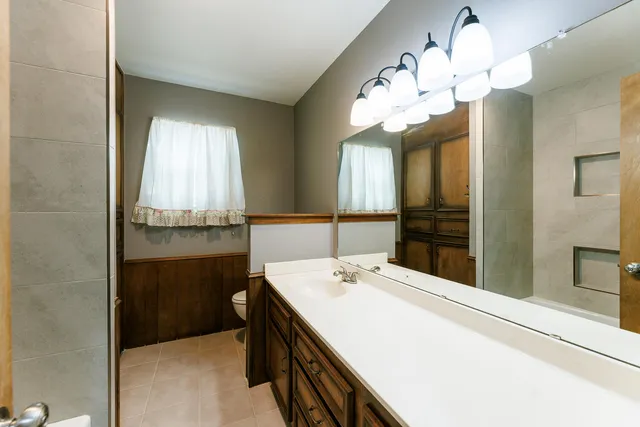 a bathroom with a sink and a large mirror