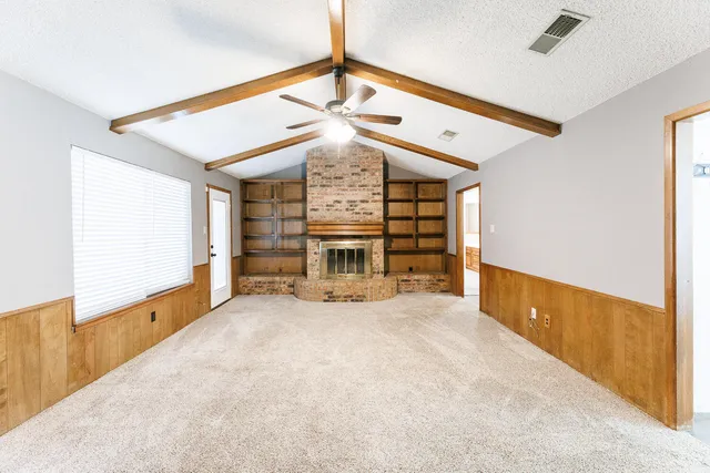 a view of an empty room with a fireplace