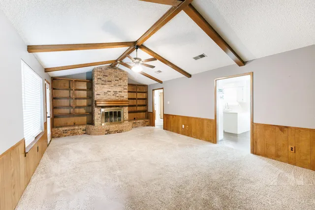 a view of an empty room with a fireplace