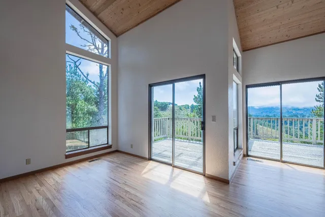 a view of an entryway with wooden floor and garden