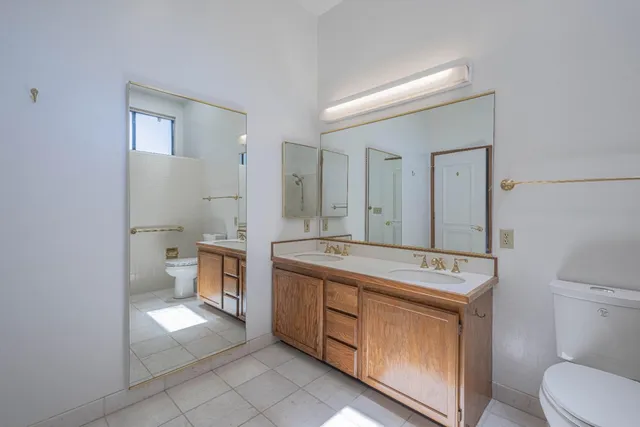 a view of bathroom with a toilet sink and mirror