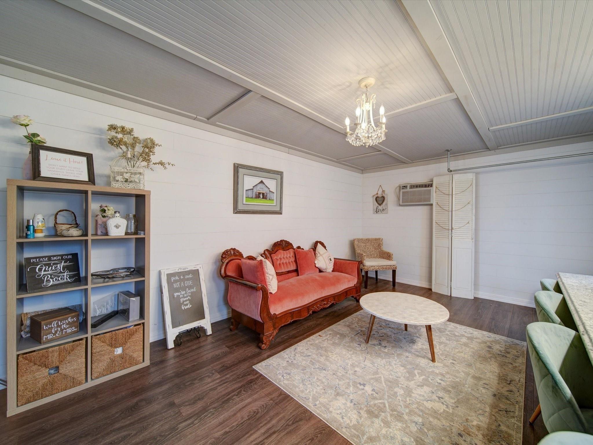 724 Bruce Thomas Road Monroe, NC 28112 - Photo 19 of 47 a living room with furniture a rug and a bookshelf