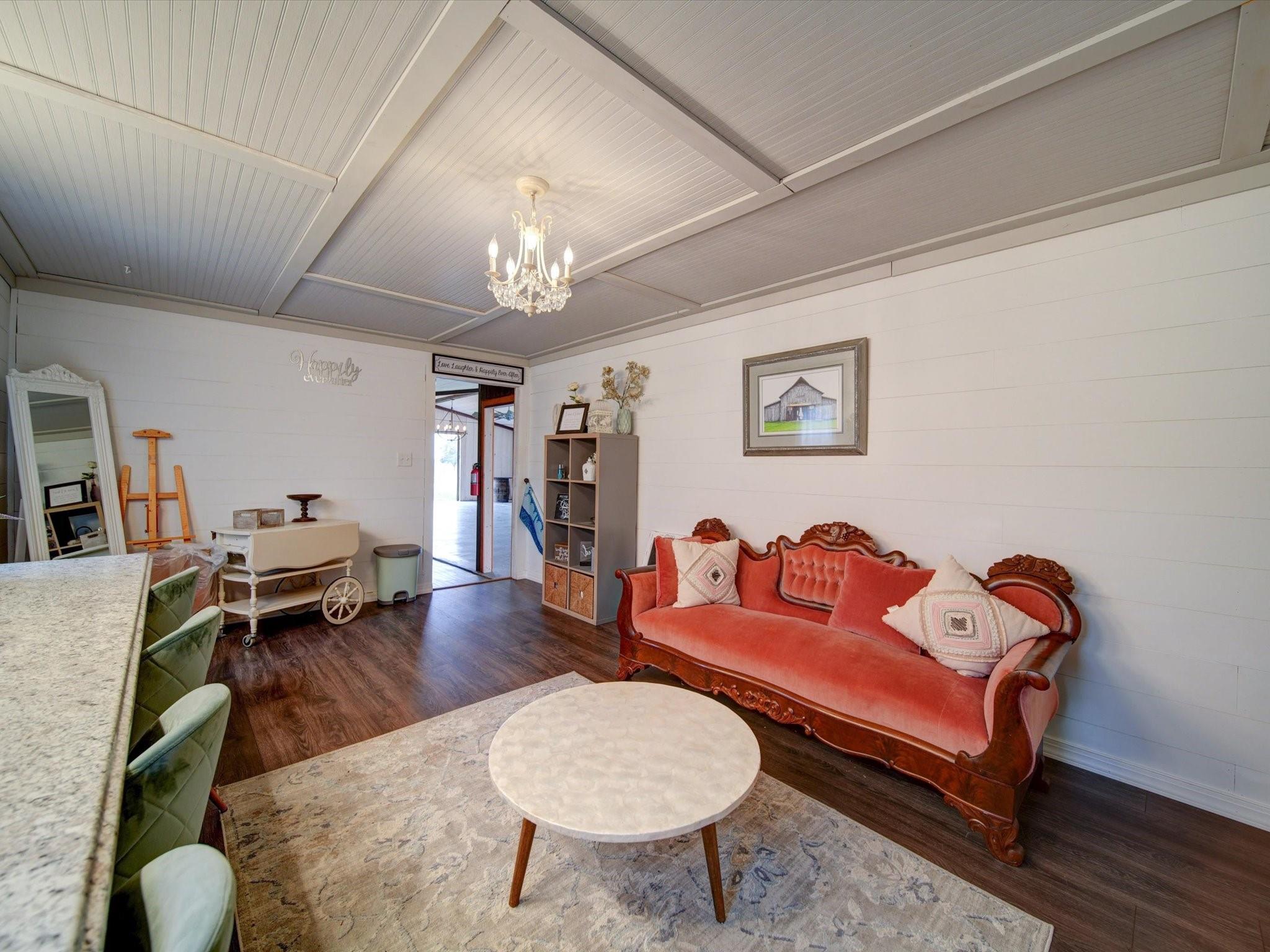 724 Bruce Thomas Road Monroe, NC 28112 - Photo 20 of 47 a living room with furniture and a chandelier