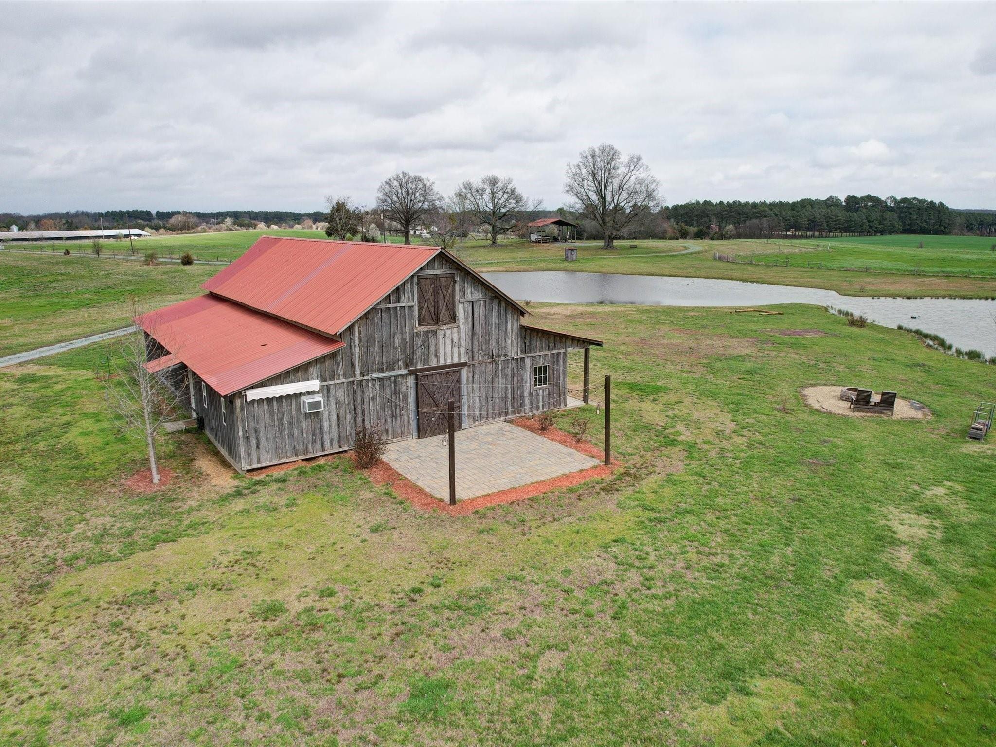 724 Bruce Thomas Road Monroe, NC 28112 - Photo 45 of 47 an aerial view of a house with a garden and lake view