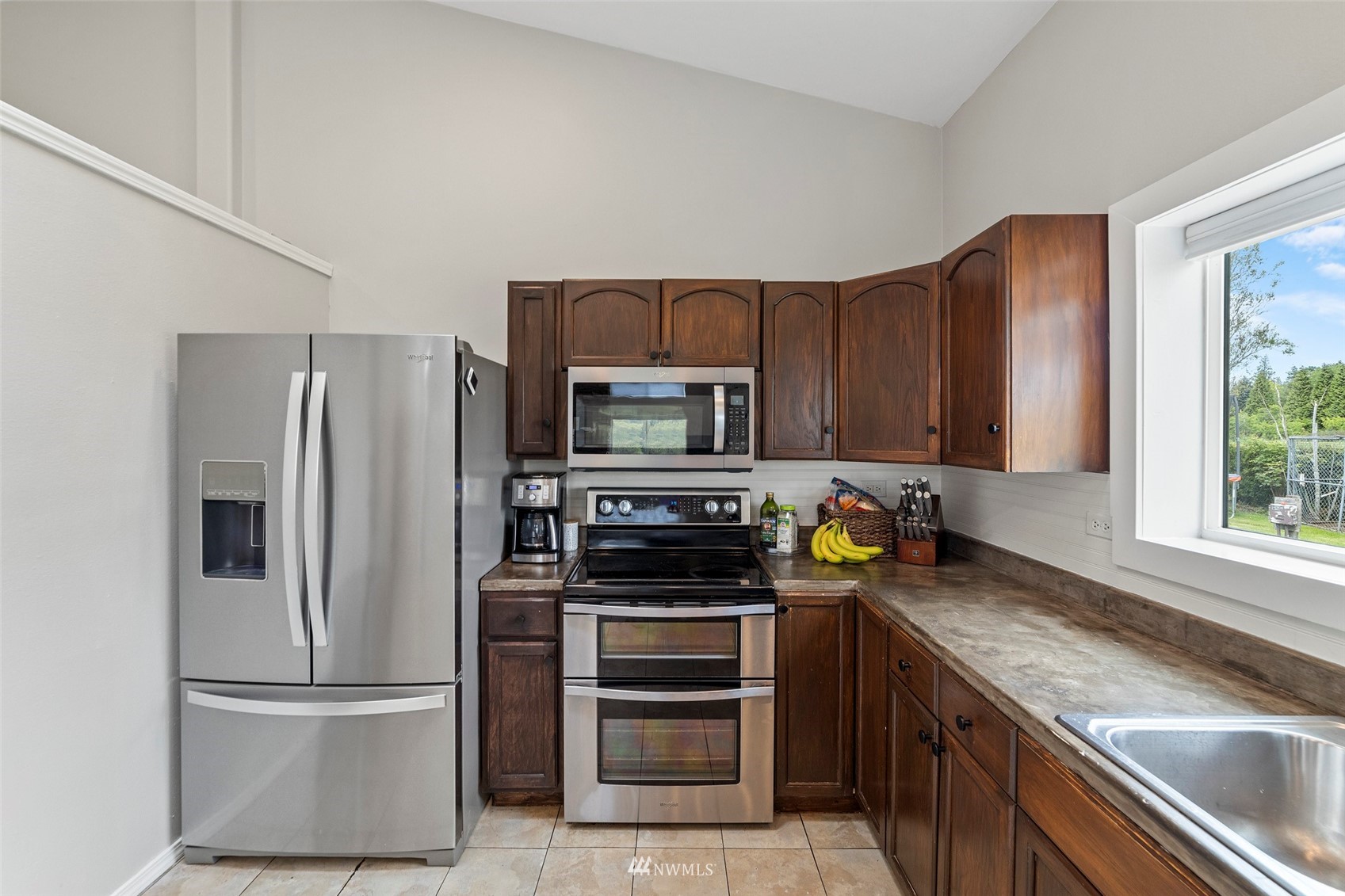3166 Douglas Road Ferndale, WA 98248 - Photo 13 of 38 a kitchen with stainless steel appliances granite countertop a refrigerator stove and microwave