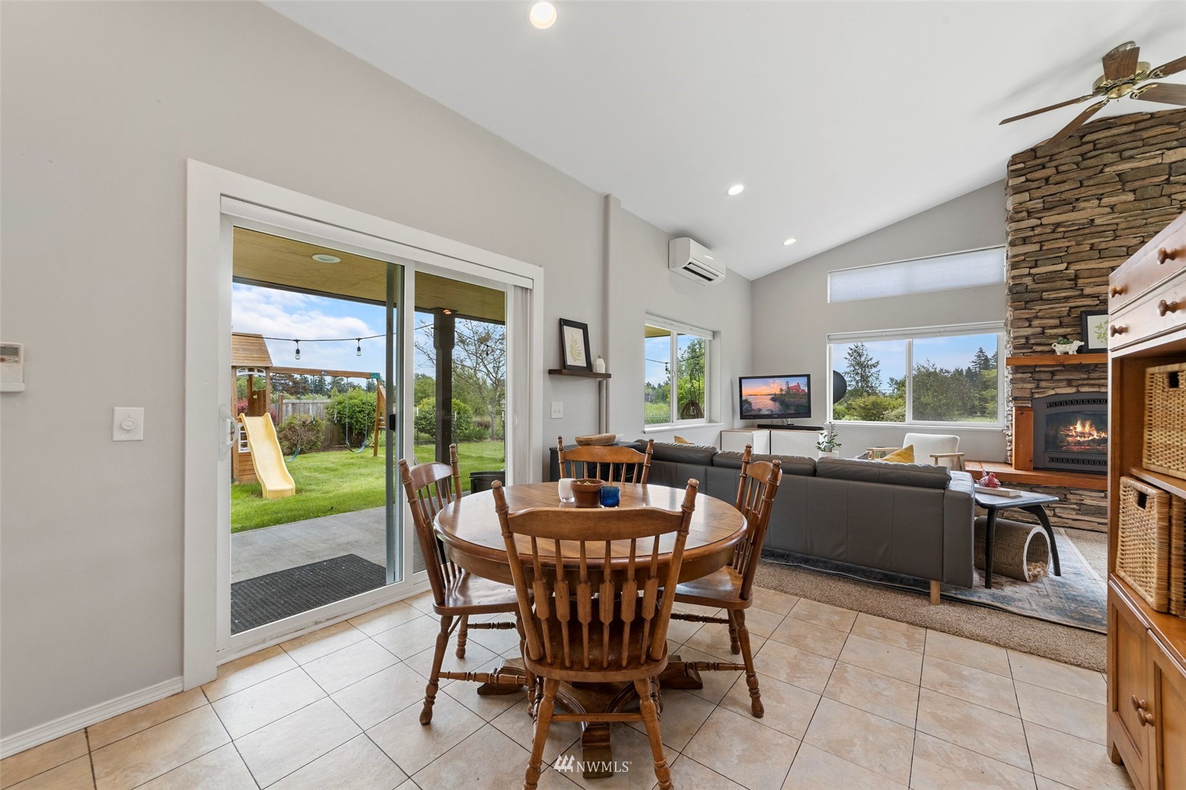 3166 Douglas Road Ferndale, WA 98248 - Photo 14 of 38 a dining room with furniture a floor to ceiling window and kitchen view