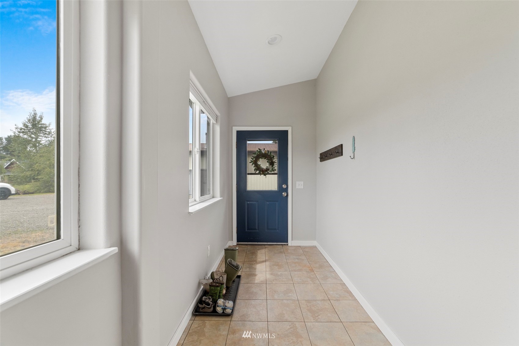 3166 Douglas Road Ferndale, WA 98248 - Photo 3 of 38 a view of a hallway with wooden floor and a bathroom