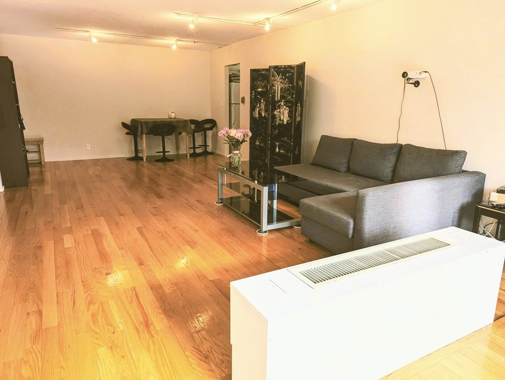 99 Pond Avenue, Unit 409 Brookline, MA 02445 - Photo 11 of 28 a terrace with outdoor seating and city view