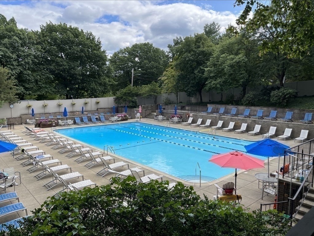 99 Pond Avenue, Unit 409 Brookline, MA 02445 - Photo 20 of 28 an outdoor space with pool and furniture