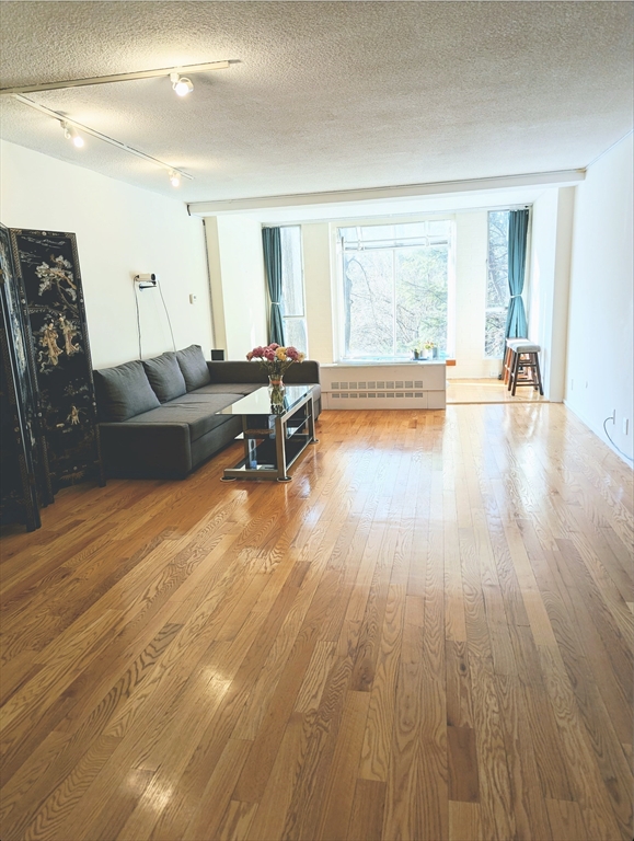 99 Pond Avenue, Unit 409 Brookline, MA 02445 - Photo 3 of 28 a living room with furniture and a large window