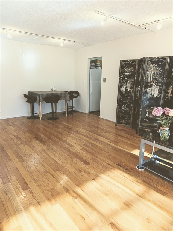 99 Pond Avenue, Unit 409 Brookline, MA 02445 - Photo 9 of 28 a view of a room with gym equipment