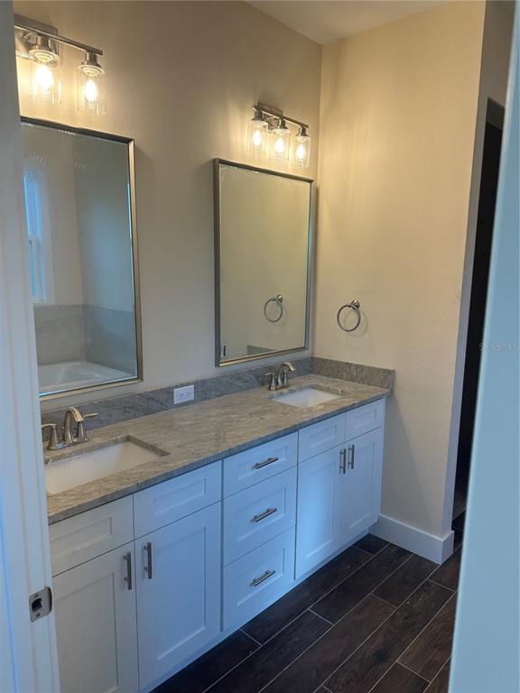 4011 Amber Road Valrico, FL 33594 - Photo 11 of 32 a bathroom with a granite countertop double vanity sink and mirror