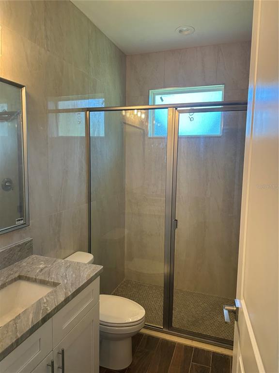 4011 Amber Road Valrico, FL 33594 - Photo 21 of 32 a bathroom with a granite countertop sink toilet and shower